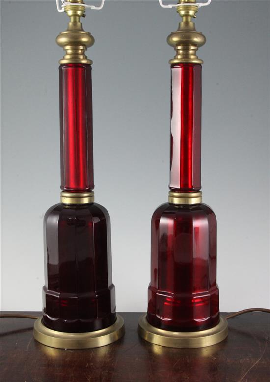 A pair of brass and ruby glass lamp bases, height to fitting 53cm